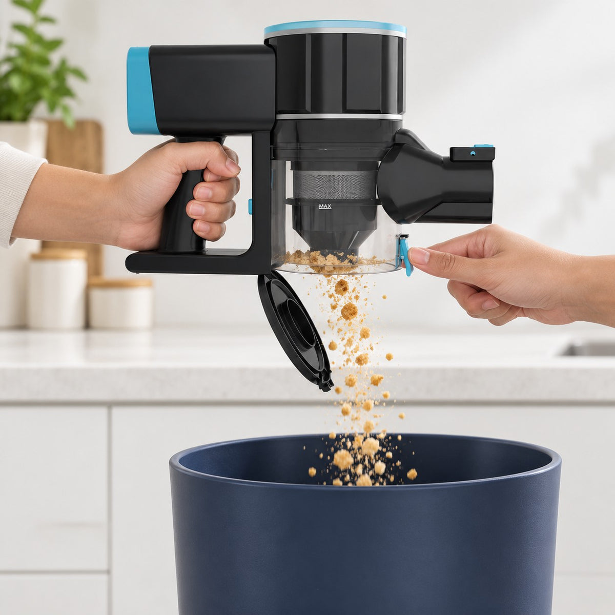 CLEAN's hinged dust-cup base open over a bin as dry crumbs fall out.