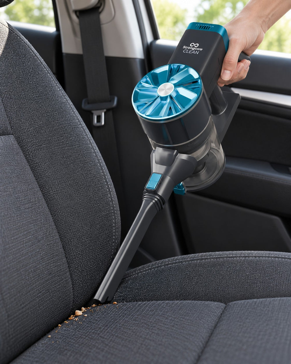 CLEAN in handheld mode with its crevice nozzle reaching a car-seat seam.