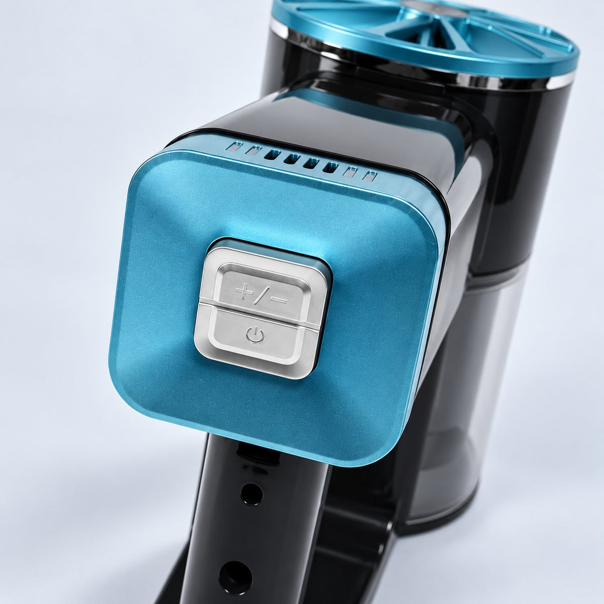 Angled close-up of CLEAN's two silver buttons: mode adjustment above and power below.