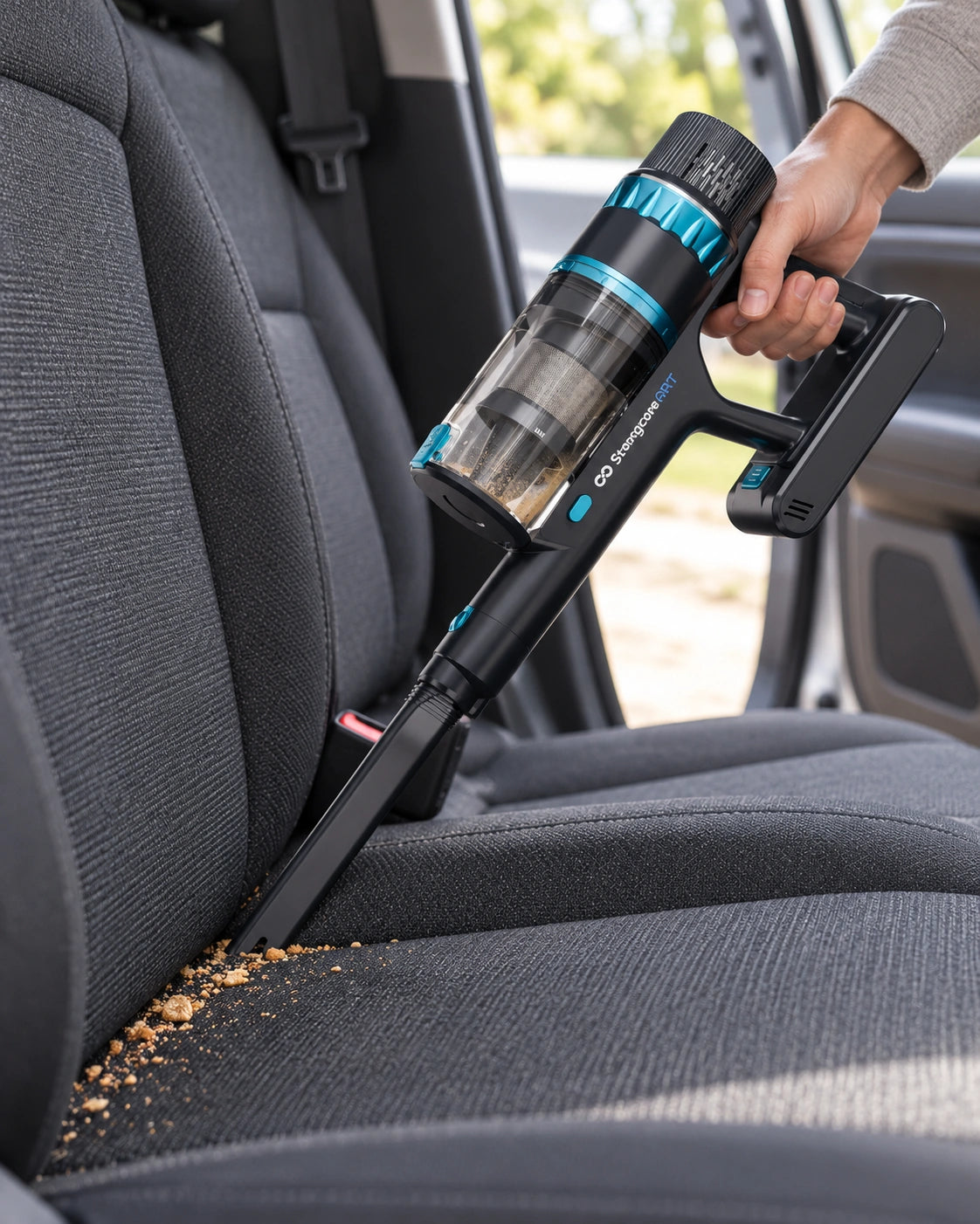 GRIT handheld with its long crevice nozzle cleaning a car-seat seam; source-led lifestyle artwork.